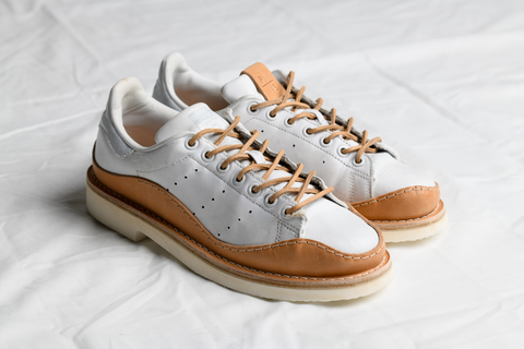 A pair of handcrafted Peterson Stoop signature redesigned Adidas Stan Smith sneakers for MUKAEMUZ