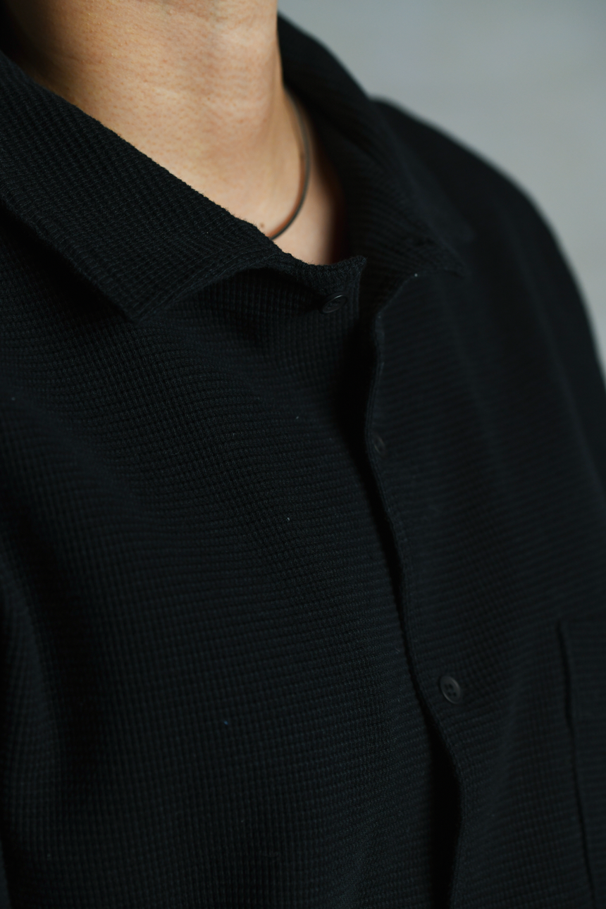 Collar and button details of OFTT Waffle Shirt in black. 