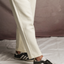 Side detail view of Waffle Trousers in Off-White by OFTT.